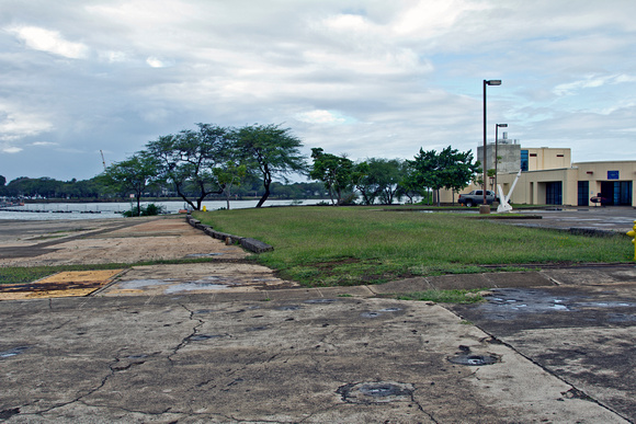 Site on Ford Island (the island in the middle of Pearl Harbor) where the first bomb fell during the attack on Pearl Harbor. The plane came from over those trees and the bomb stuck at the edge of the g